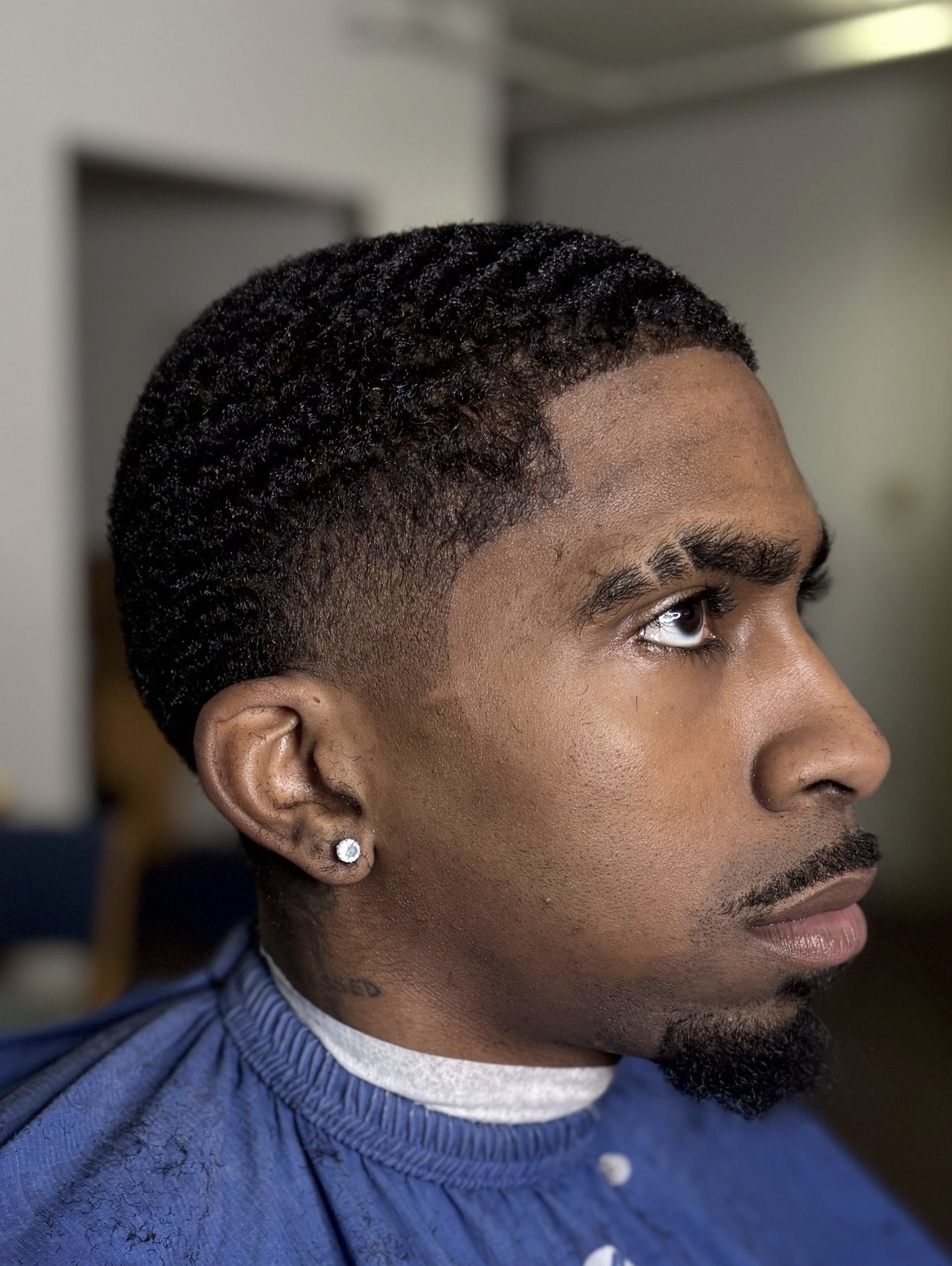 Sharp taper fade with textured wave crop and clean part, side profile, TaeChoppedHim Mount Clemens MI